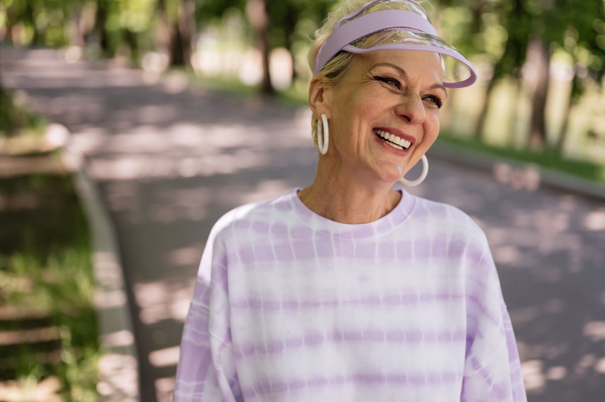 A woman in her fifties looking calm and thoughtful