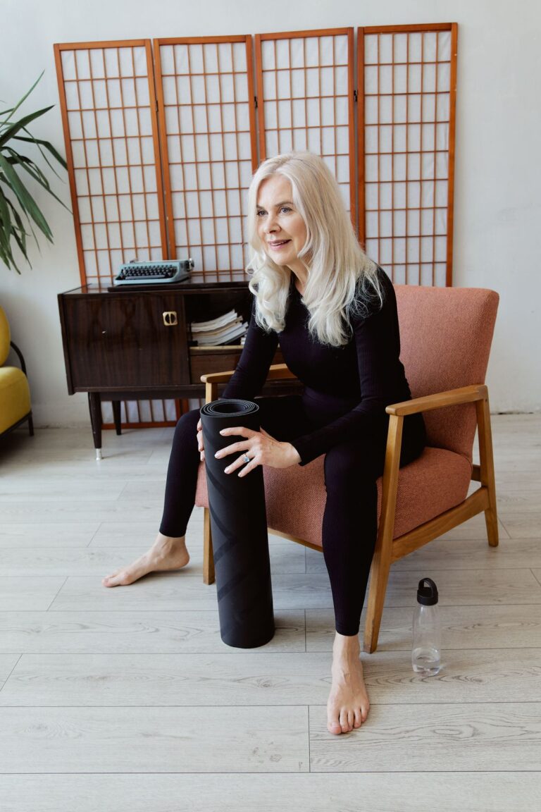 Mature woman with a yoga mat