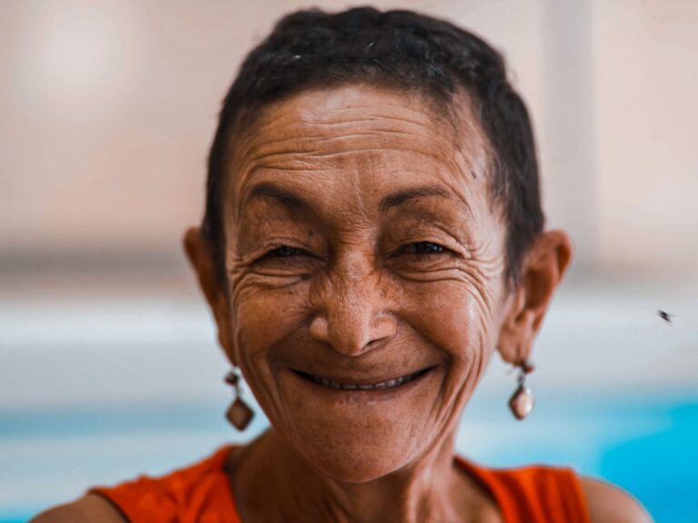 Smiling woman in an orange top