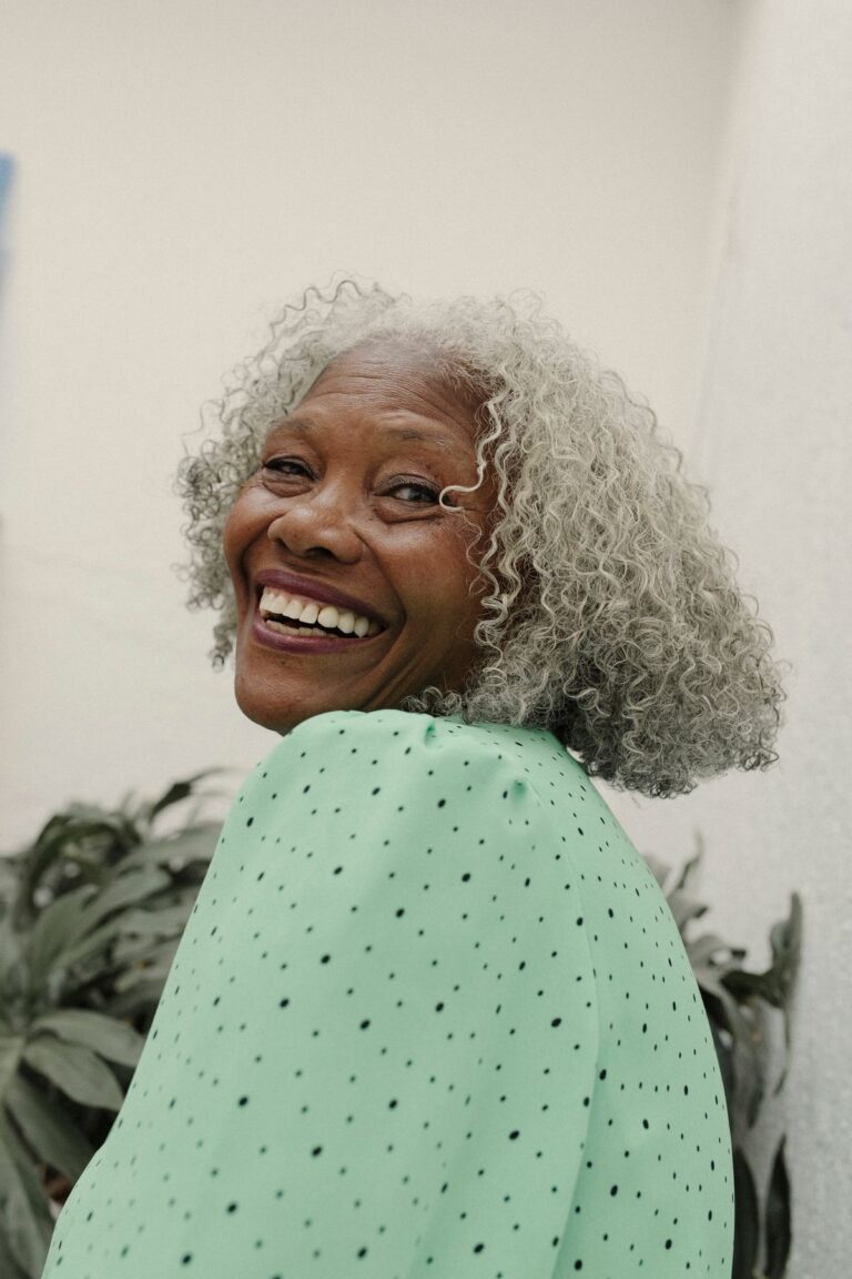 Joyful senior woman in green