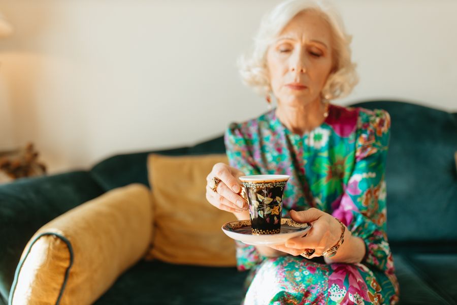 Woman relaxing calmly at home with a warm drink