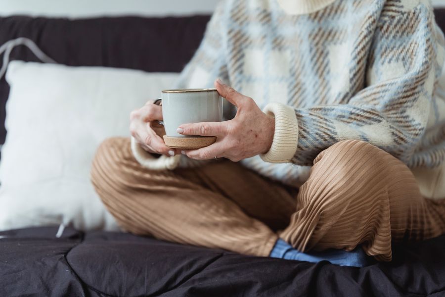 Woman resting calmly at home with a warm cup