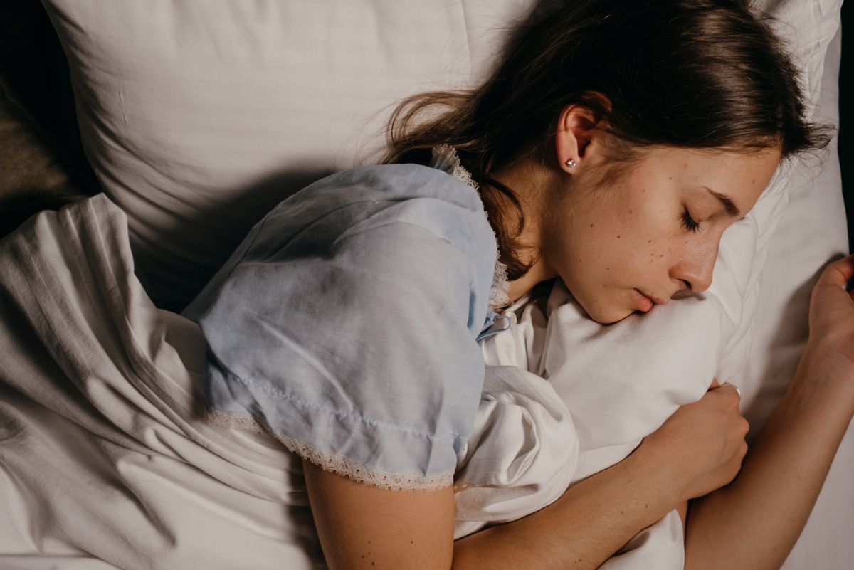 A woman resting in bed at night