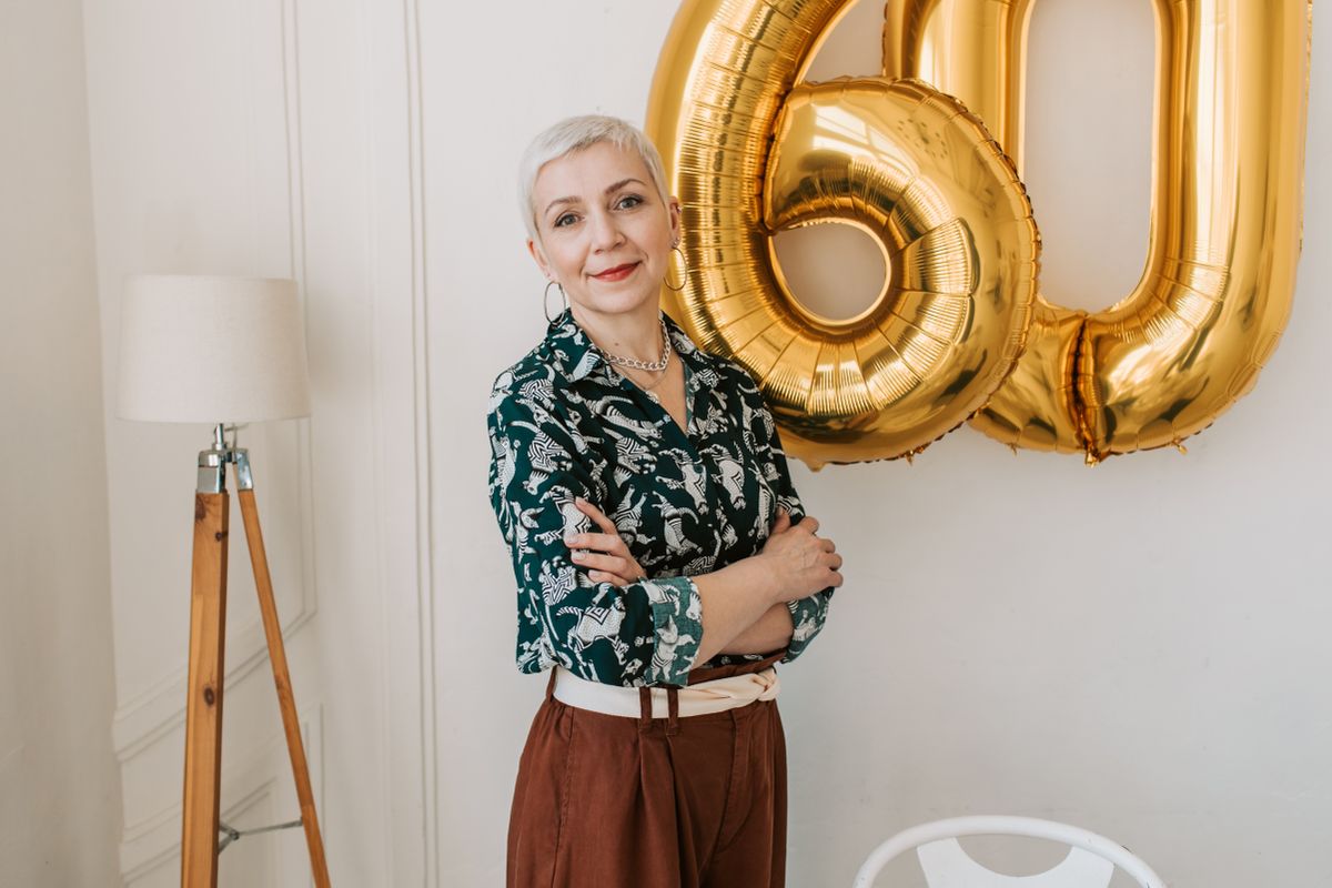 A smiling woman in her forties outdoors